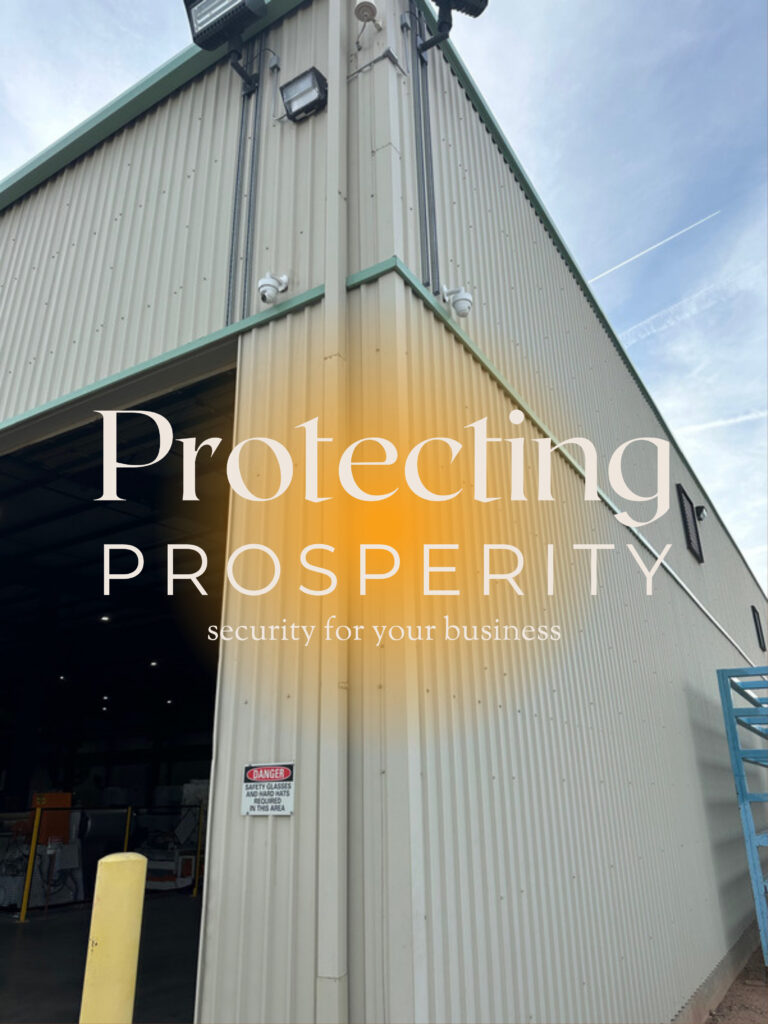 Protecting Prosperity - in background is a metal building with CCTV security cameras